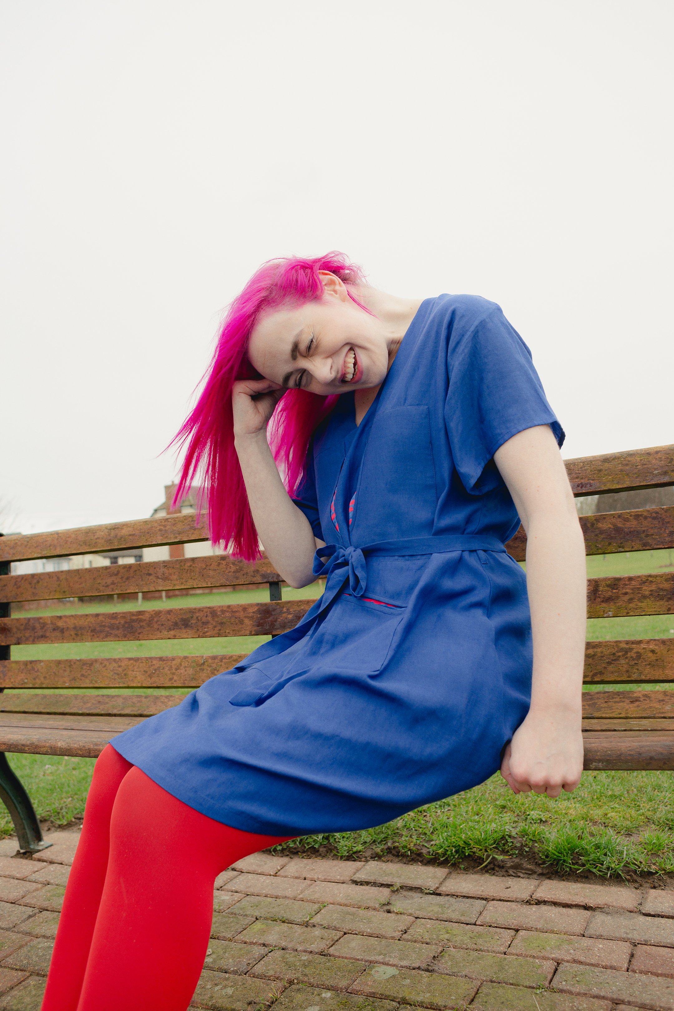 Emma Lawton wears a blue print dress by [Reset] with her own red tights